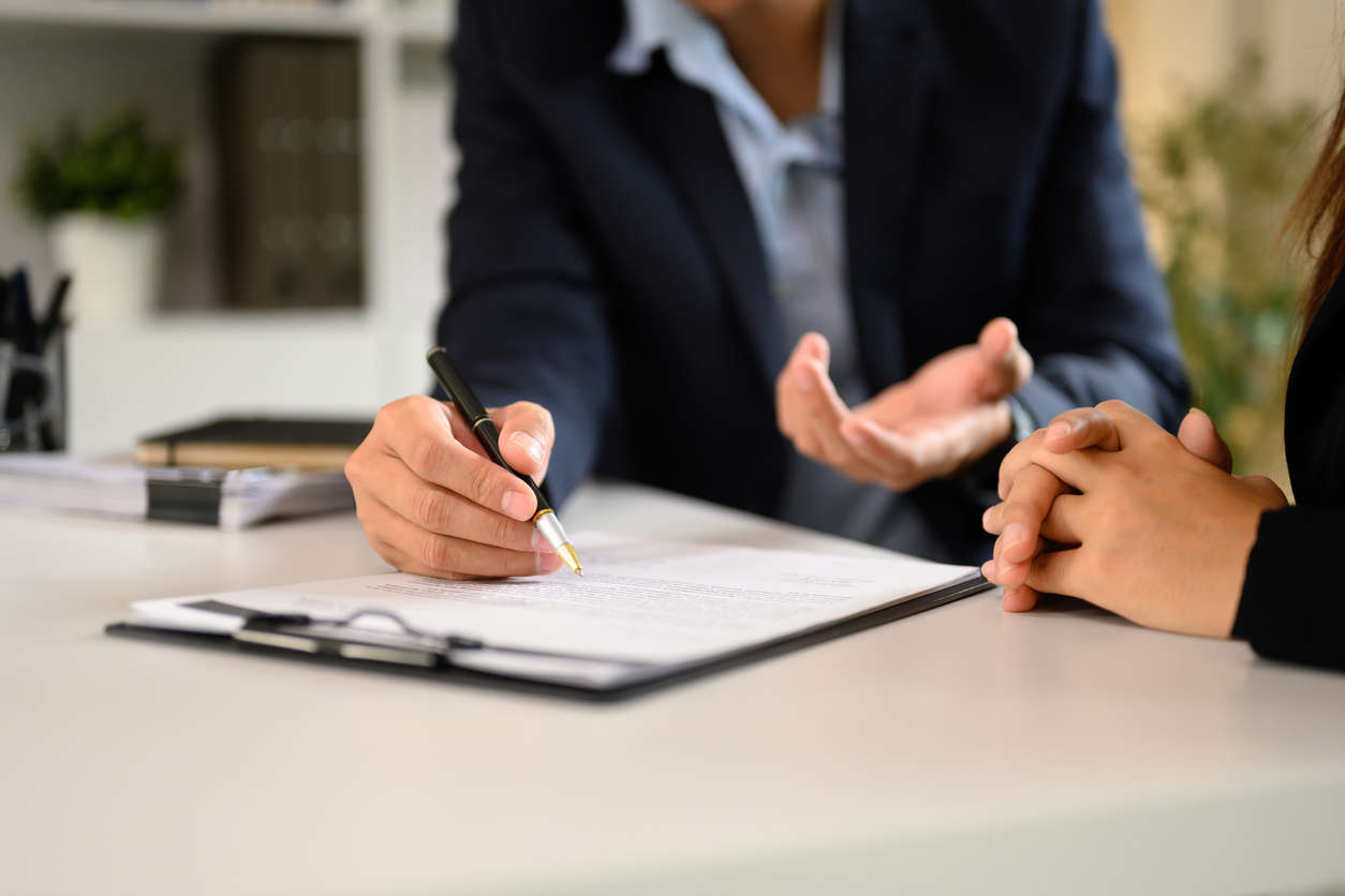 Two attorneys reviewing the terms of a fee sharing agreement